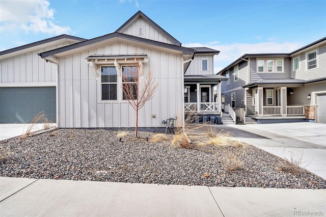 modern farmhouse style home featuring a garage, board and batten siding, a porch, and concrete driveway