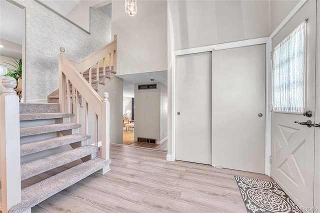 5543 S Kenton Ct, Englewood, CO 80111 - foyer entrance with wood finished floors, stairs, and a high ceiling