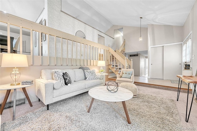 5543 S Kenton Ct, Englewood, CO 80111 - living area featuring high vaulted ceiling, stairs, and carpet flooring