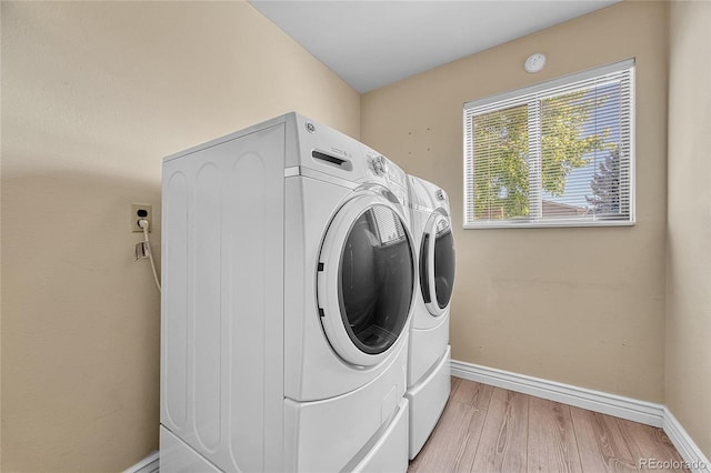 5543 S Kenton Ct, Englewood, CO 80111 - laundry area featuring washing machine and clothes dryer and light wood-style floors