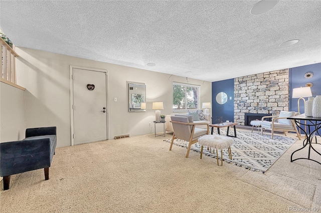 5543 S Kenton Ct, Englewood, CO 80111 - carpeted living room featuring a textured ceiling and a stone fireplace