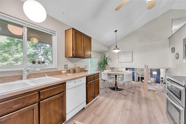 5543 S Kenton Ct, Englewood, CO 80111 - kitchen featuring dishwasher, double oven range, lofted ceiling, light wood-style floors, and pendant lighting