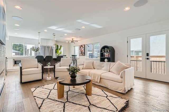 living room with light hardwood / wood-style floors and french doors