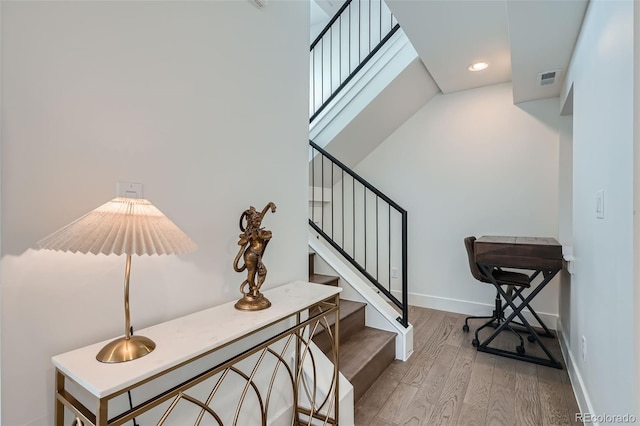 stairs featuring wood-type flooring