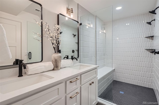 bathroom with tile patterned flooring, vanity, and an enclosed shower