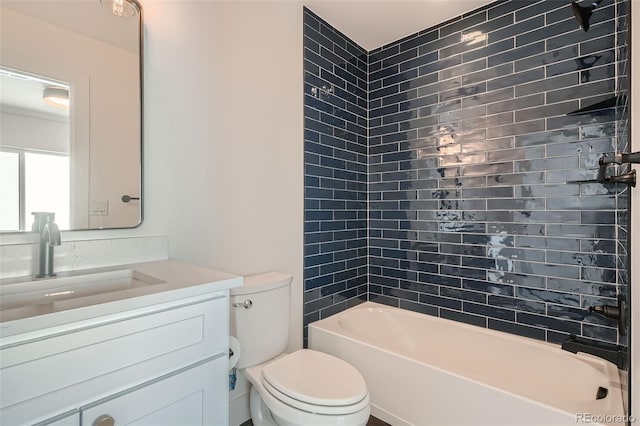 full bathroom featuring vanity, toilet, and tiled shower / bath