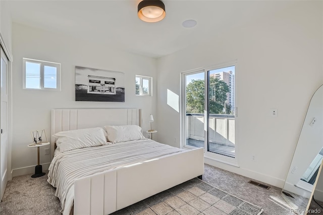 carpeted bedroom with access to exterior