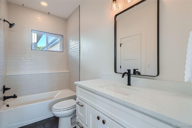 full bathroom featuring vanity, tiled shower / bath combo, toilet, and tile patterned flooring