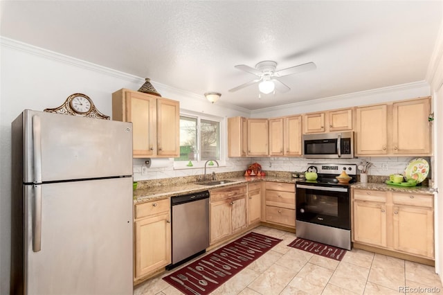 kitchen featuring ceiling fan, sink, light brown cabinets, light stone counters, and appliances with stainless steel finishes