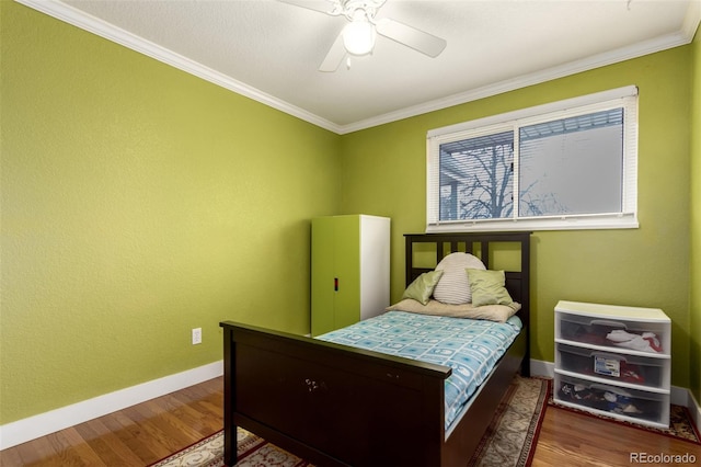 bedroom with hardwood / wood-style floors, ceiling fan, and ornamental molding