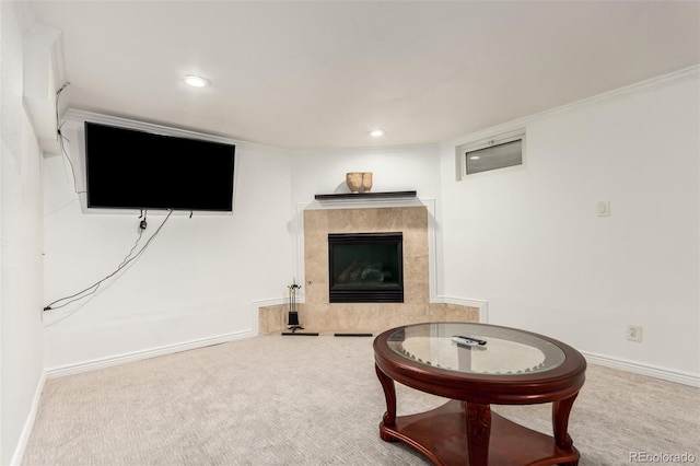 carpeted living room with a tile fireplace and crown molding