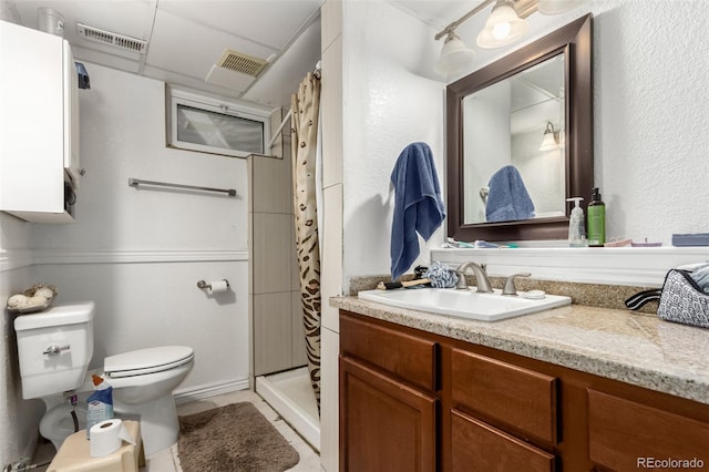 bathroom with tile patterned floors, a shower with curtain, vanity, and toilet