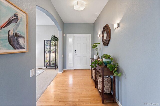 4515 W 107th Cir, Westminster, CO 80031 - foyer entrance with arched walkways and light wood-type flooring
