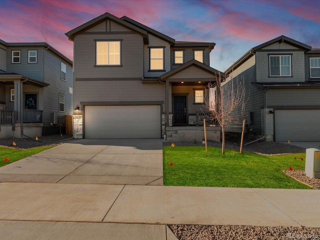 view of front of house with a garage and a yard