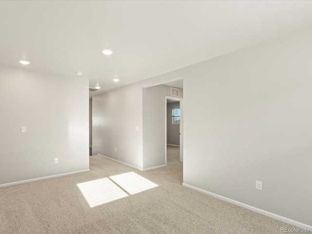 unfurnished room with light carpet