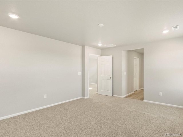 unfurnished room with light colored carpet