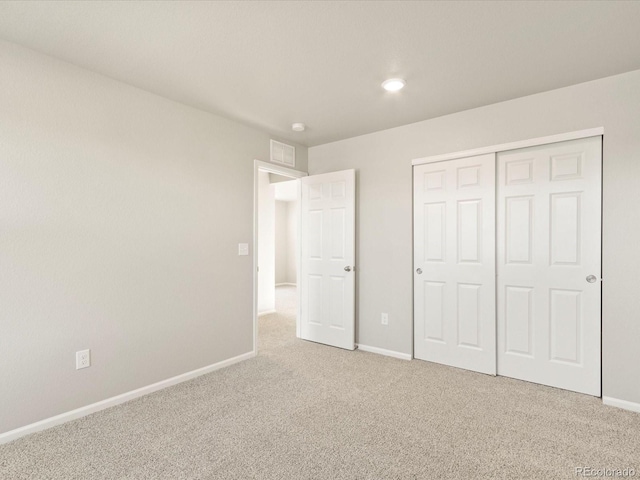 unfurnished bedroom with carpet and a closet