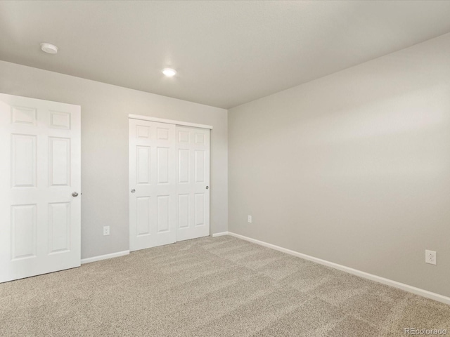 unfurnished bedroom featuring a closet and carpet floors