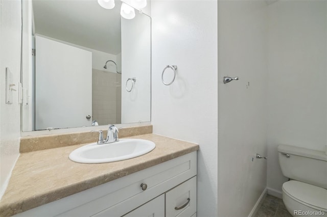 bathroom with tile patterned floors, a shower, vanity, and toilet