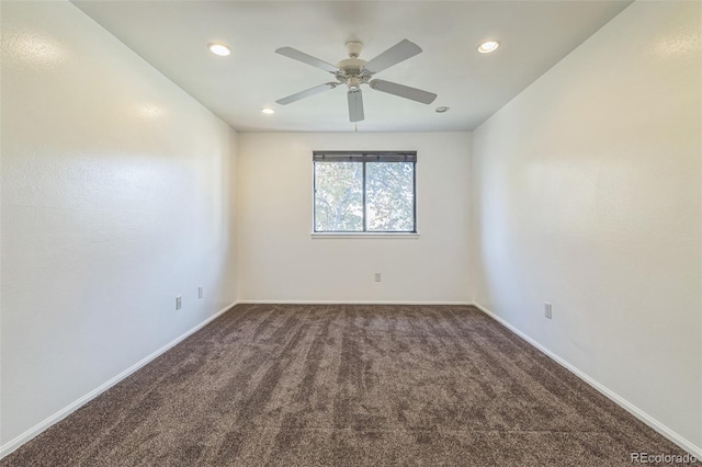 carpeted spare room featuring ceiling fan