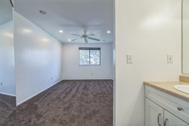 interior space featuring ceiling fan and sink