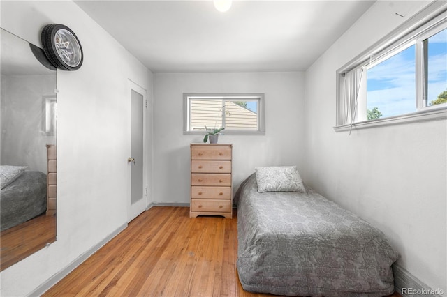 935 S Pecos Way, Denver, CO 80223 - bedroom with multiple windows and light wood-type flooring