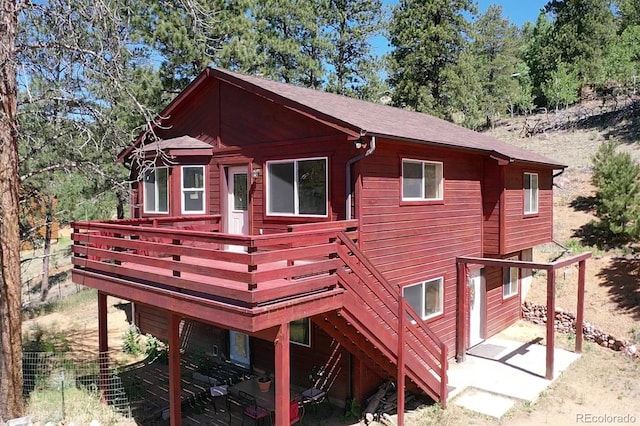 back of house with a wooden deck