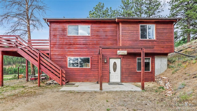 view of front of home featuring stairway and a patio area