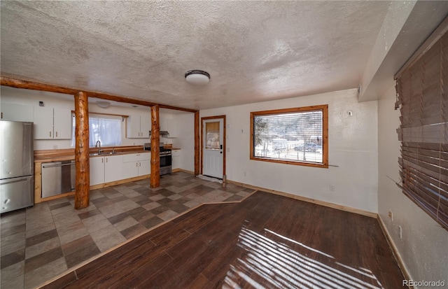 interior space featuring sink, dark hardwood / wood-style floors, and a textured ceiling