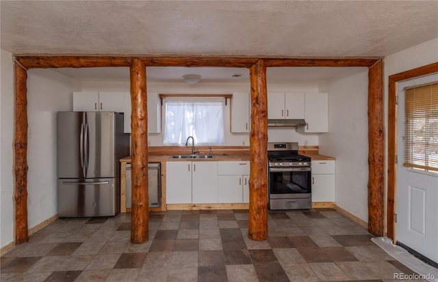 kitchen featuring a textured ceiling, sink, white cabinetry, and stainless steel appliances