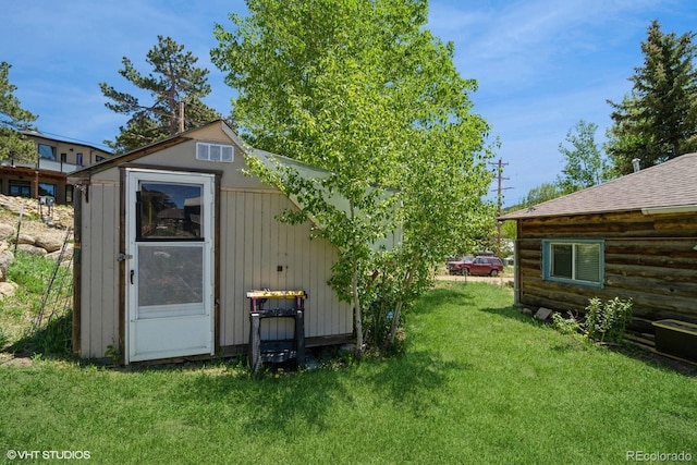 view of outbuilding with a lawn