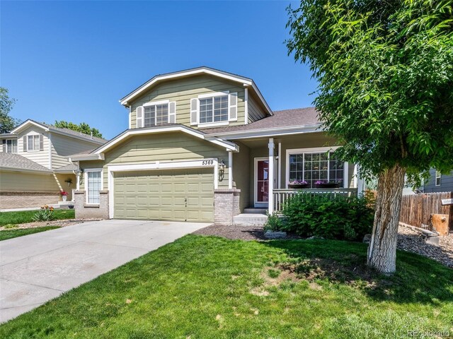 5369 Creek Way, Parker, CO 80134 - tri-level home featuring an attached garage, covered porch, brick siding, and concrete driveway