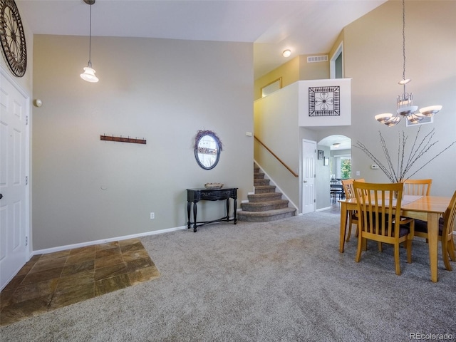 5369 Creek Way, Parker, CO 80134 - carpeted dining space featuring stairs, arched walkways, a chandelier, baseboards, and a towering ceiling