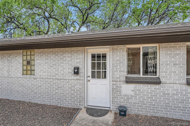 entrance to property with brick siding