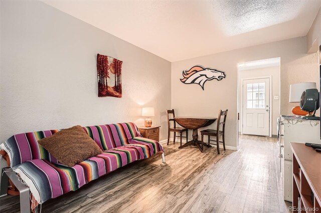 living area with wood finished floors and baseboards