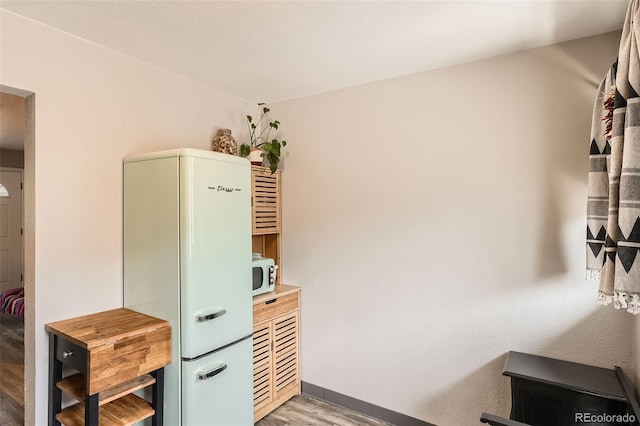 office area featuring light wood-type flooring and baseboards