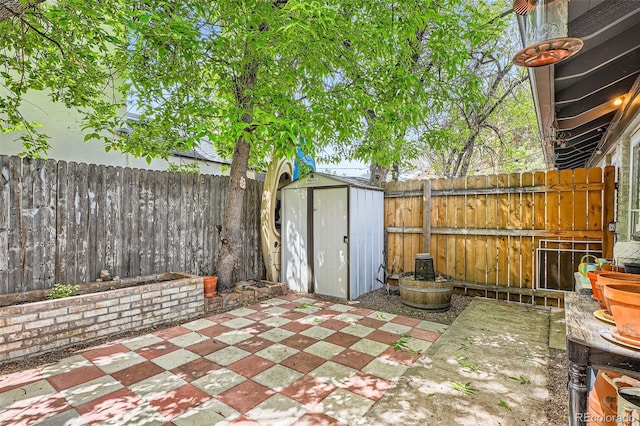 view of patio / terrace with a storage shed, a fenced backyard, and an outbuilding