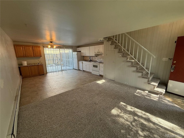 8682 W 51st Ave, Arvada, CO 80002 - unfurnished living room with ceiling fan, stairs, and baseboard heating