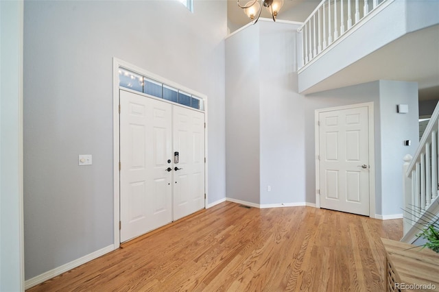 20339 Vista Cir, Parker, CO 80138 - foyer entrance with stairway, a high ceiling, and light wood-type flooring