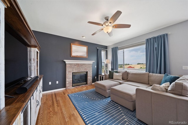 20339 Vista Cir, Parker, CO 80138 - living room featuring light wood-type flooring, a ceiling fan, and a fireplace