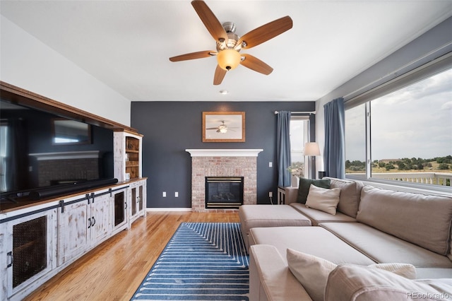 20339 Vista Cir, Parker, CO 80138 - living area with a brick fireplace, a ceiling fan, and light wood-type flooring
