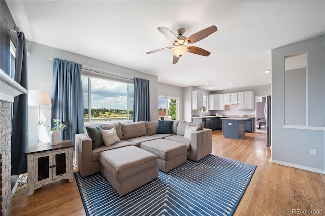 20339 Vista Cir, Parker, CO 80138 - living area featuring light wood-style floors, ceiling fan, and a brick fireplace