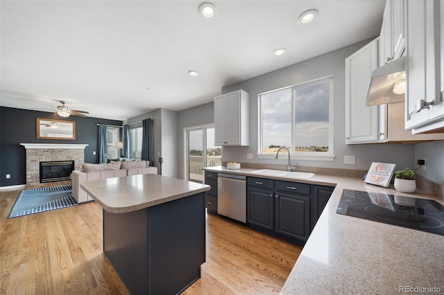 20339 Vista Cir, Parker, CO 80138 - kitchen featuring stainless steel dishwasher, black electric cooktop, under cabinet range hood, a center island, and white cabinetry