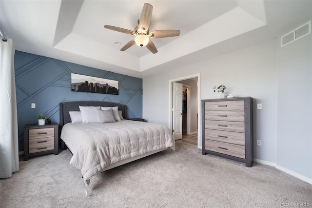 20339 Vista Cir, Parker, CO 80138 - bedroom featuring a raised ceiling, light carpet, and a ceiling fan
