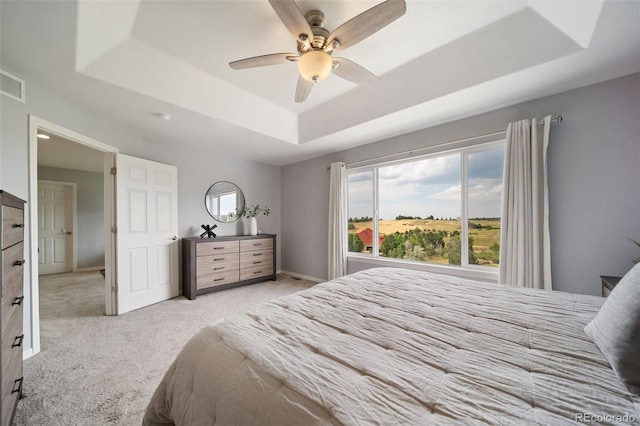 20339 Vista Cir, Parker, CO 80138 - bedroom featuring a tray ceiling, light carpet, and a ceiling fan