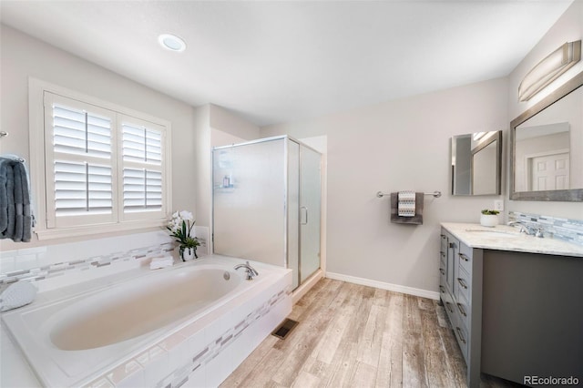 20339 Vista Cir, Parker, CO 80138 - bathroom with vanity, a bath, a shower stall, and wood finished floors