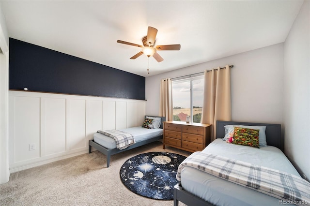 20339 Vista Cir, Parker, CO 80138 - carpeted bedroom featuring a decorative wall, wainscoting, and ceiling fan