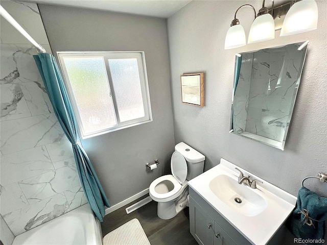 full bathroom with hardwood / wood-style floors, vanity, toilet, and shower / bathtub combination with curtain