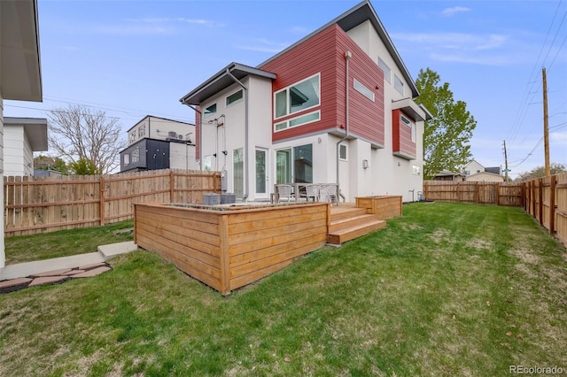 4390 Osage St, Denver, CO 80211 - rear view of property featuring stucco siding, a lawn, and a fenced backyard