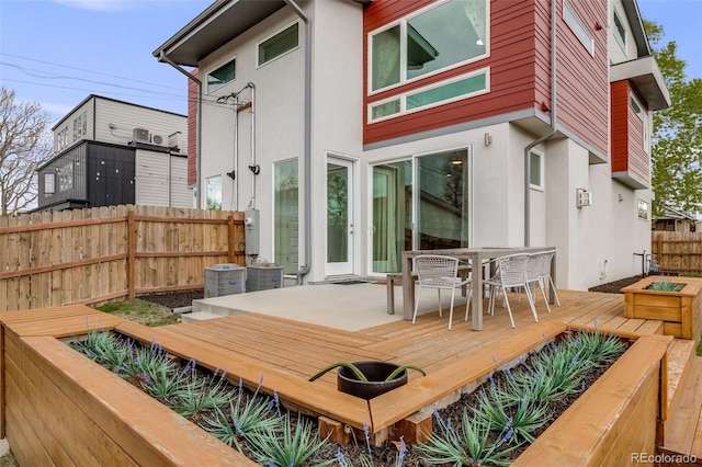 4390 Osage St, Denver, CO 80211 - rear view of property with outdoor dining space, fence, central AC, stucco siding, and a wooden deck